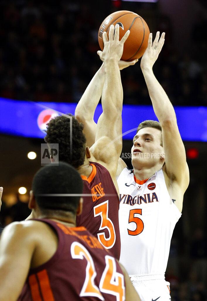 Steve Helber Virginia guard Kyle Guy (5) takes a shot over Virginia Tech guard Wabissa Bede (3) during the first half of an NCAA college basketball game in Charlottesville, Va., Tuesday, Jan. 15, 2019. (AP Photo/Steve Helber)