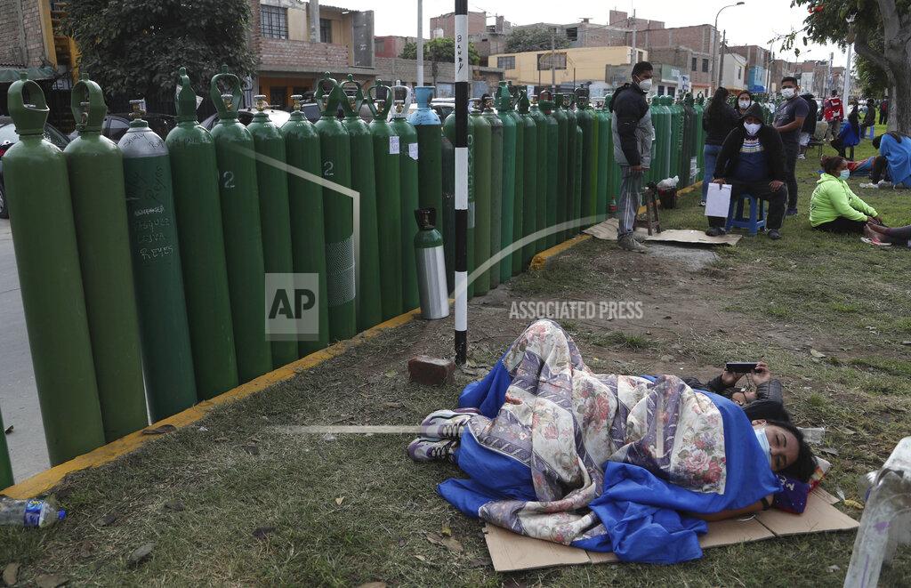 Martin Mejia People lay next to their empty oxygen tanks as many wait for the refill shop to open in Callao, Peru, Monday, Jan. 25, 2021, amid the COVID-19 pandemic. A crisis over the supply of medical oxygen for coronavirus patients has struck nations in Africa and Latin America, where warnings went unheeded at the start of the pandemic and doctors say the shortage has led to unnecessary deaths. (AP Photo/Martin Mejia)