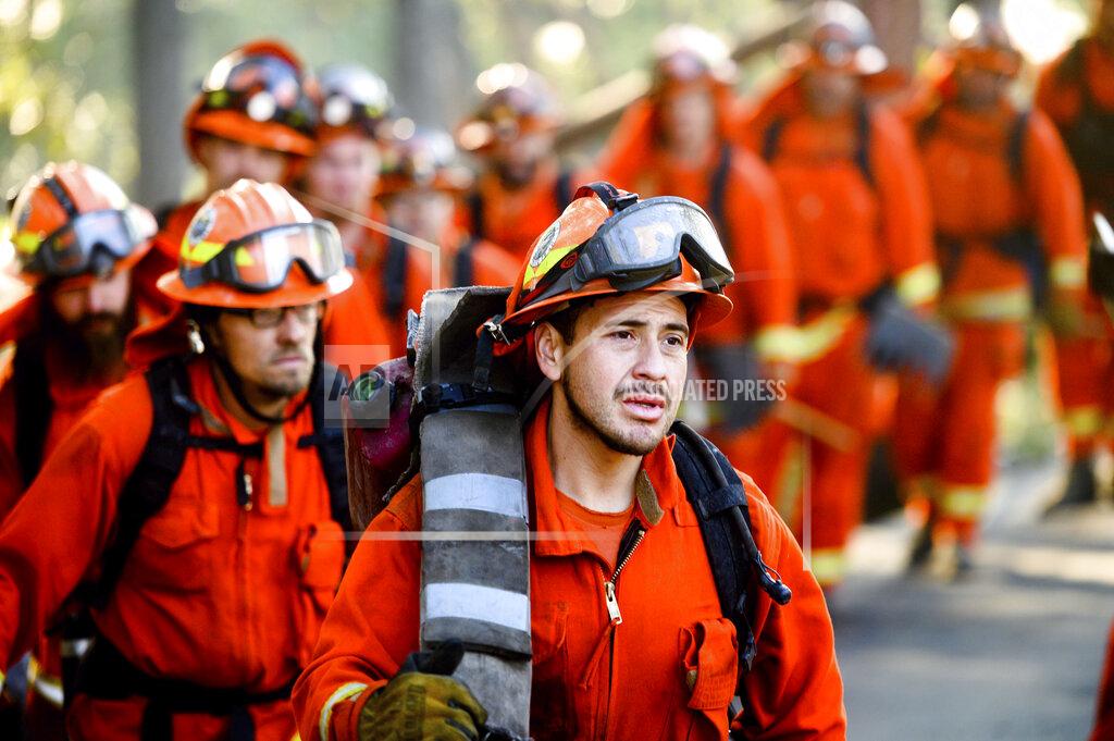 FILE - In this Oct. 29, 2019, file photo, inmate firefighters prepare to battle the Kincade Fire near Healdsburg, Calif. Despite pandemic restrictions, the California legislature managed to pass hundreds of bills in 2020, including one that would allow former inmate firefighters to quickly apply to have their criminal records expunged after their release, which gives them a shot at becoming professional firefighters or seeking employment in other licensed professions. (AP Photo/Noah Berger, File)