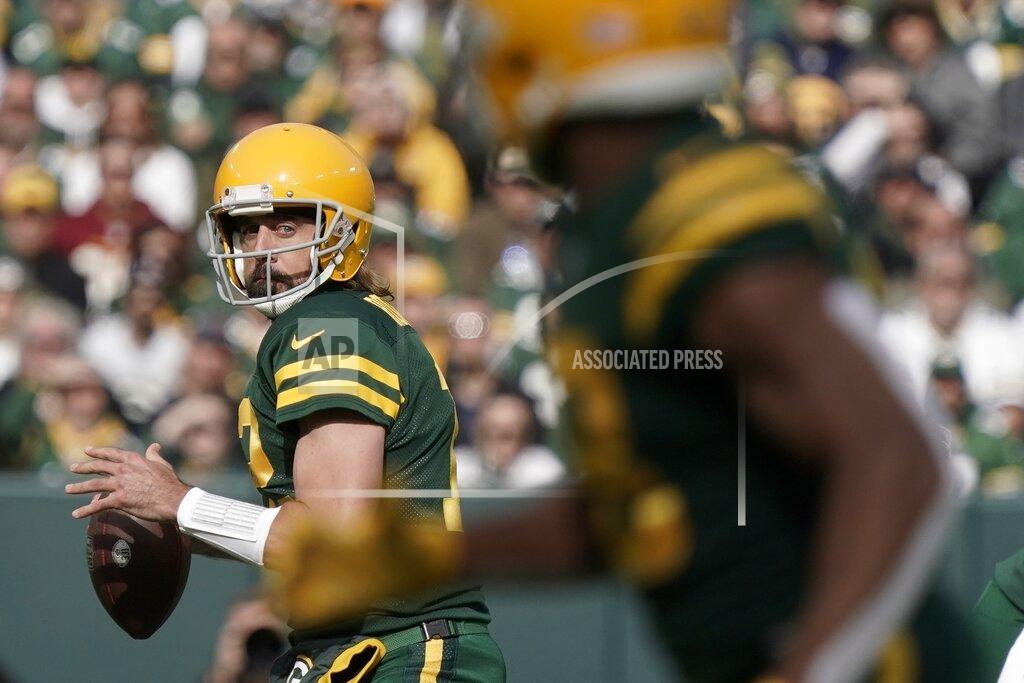 Morry Gash Green Bay Packers' Aaron Rodgers looks to pass during the first half of an NFL football game against the Washington Football Team Sunday, Oct. 24, 2021, in Green Bay, Wis. (AP Photo/Morry Gash)