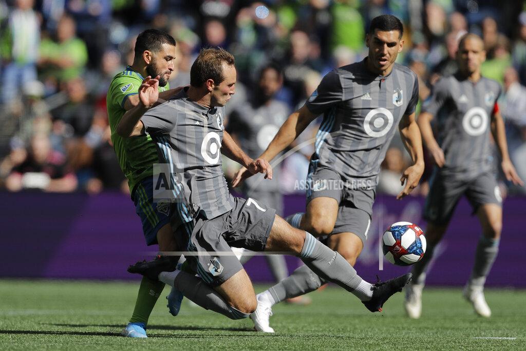 Ted S. Warren Minnesota United midfielder Kevin Molino, second from left, gets to a ball in front of Seattle Sounders forward Nicolas Lodeiro, left, during the first half of an MLS soccer match, Sunday, Oct. 6, 2019, in Seattle. The Sounders won 1-0. (AP Photo/Ted S. Warren)