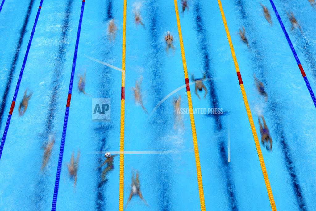 David J. Phillip Swimmers warm up before competition at the 2020 Summer Olympics, Sunday, July 25, 2021, in Tokyo. (AP Photo/David J. Phillip)