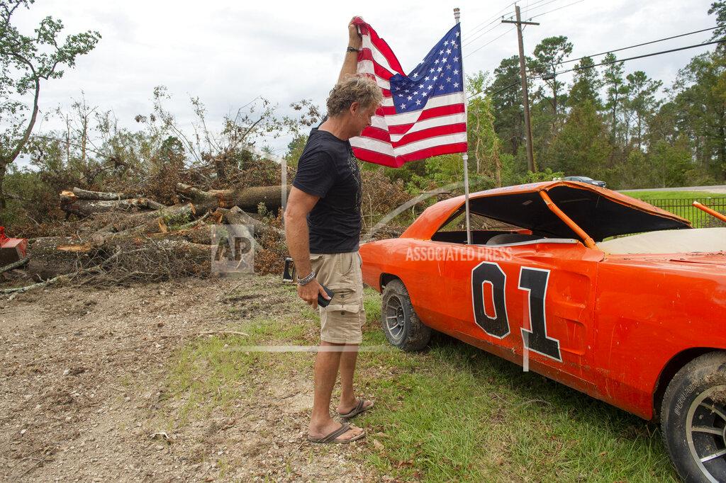 Chris Granger Actor John Schneider, who starred in the television show "The Dukes of Hazzard," checks on one of his "General Lee" cars on Monday, Sept. 6, 2021, in Holden, La., that was destroyed by Hurricane Ida. The car was made famous during the show which aired in the early eighties. (Chris Granger/The Times-Picayune/The New Orleans Advocate via AP)