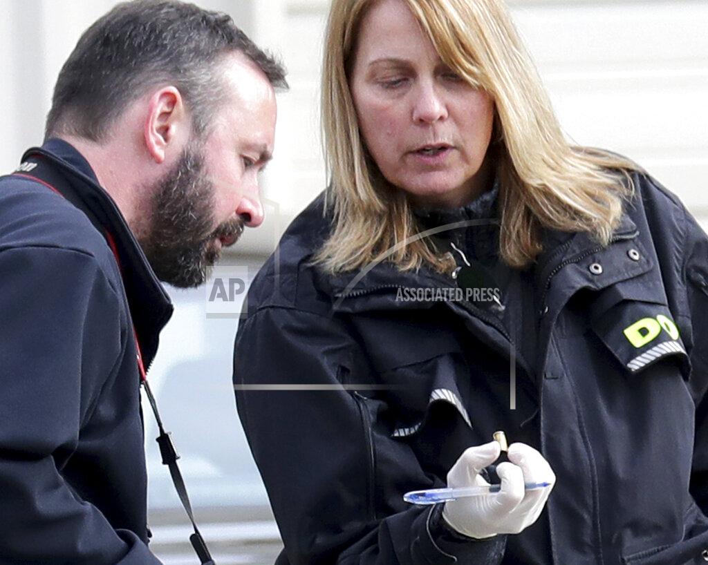 Mike De Sisti Officials investigate what appears to be a shell casing at the scene of a deadly shooting at Somers House Tavern in Kenosha, Wis., Sunday, April 18, 2021. Several people were killed and two were seriously wounded in a shooting at the busy tavern in southeastern Wisconsin early Sunday, sheriff's officials said. (Mike De Sisti/Milwaukee Journal-Sentinel via AP)