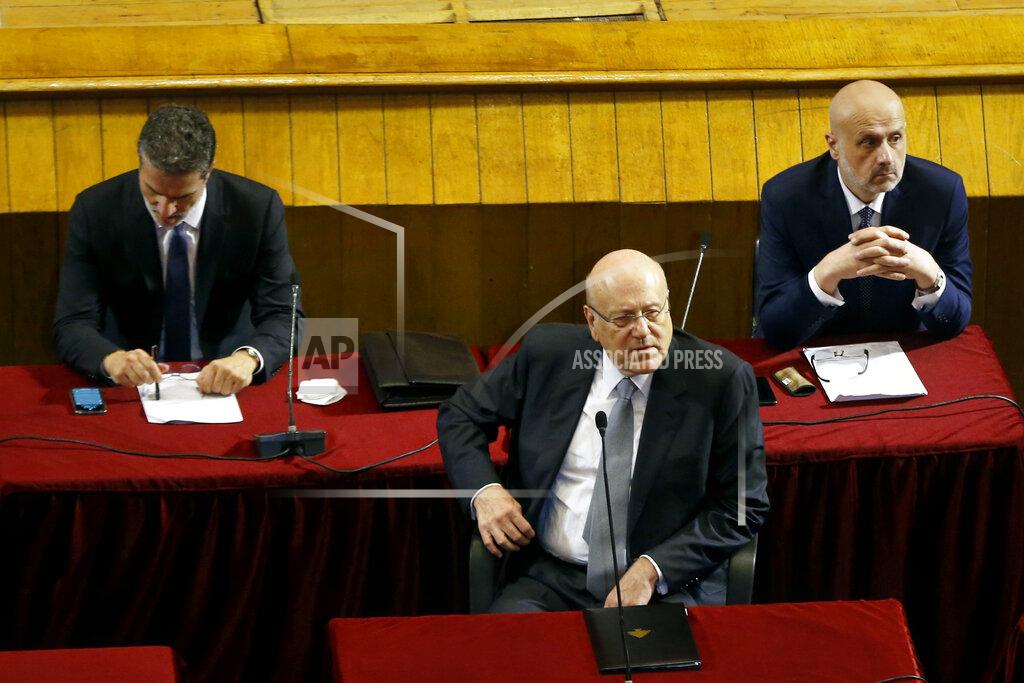 Bilal Hussein Lebanese Prime Minister Najib Mikati, center, attends a parliament session to confirm Lebanon's new government at a Beirut theater known as the UNESCO palace so that parliament members could observe social distancing measures imposed over the coronavirus pandemic, Lebanon, Monday, Sept. 20, 2021. A power outage and a broken generator briefly delayed the start of the parliament session for some 40 minutes before electricity came back on. (AP Photo/Bilal Hussein)