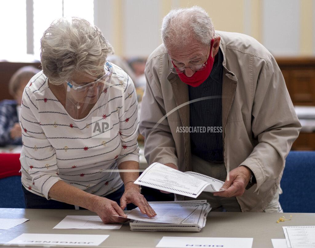 Ben Gray Officials sort ballots during an audit at the Floyd County administration building in Rome, Ga. on Friday morning, Nov. 13, 2020. Election officials in Georgia’s 159 counties are undertaking a hand tally of the presidential race that stems from an audit required by state law. (AP Photo/Ben Gray)