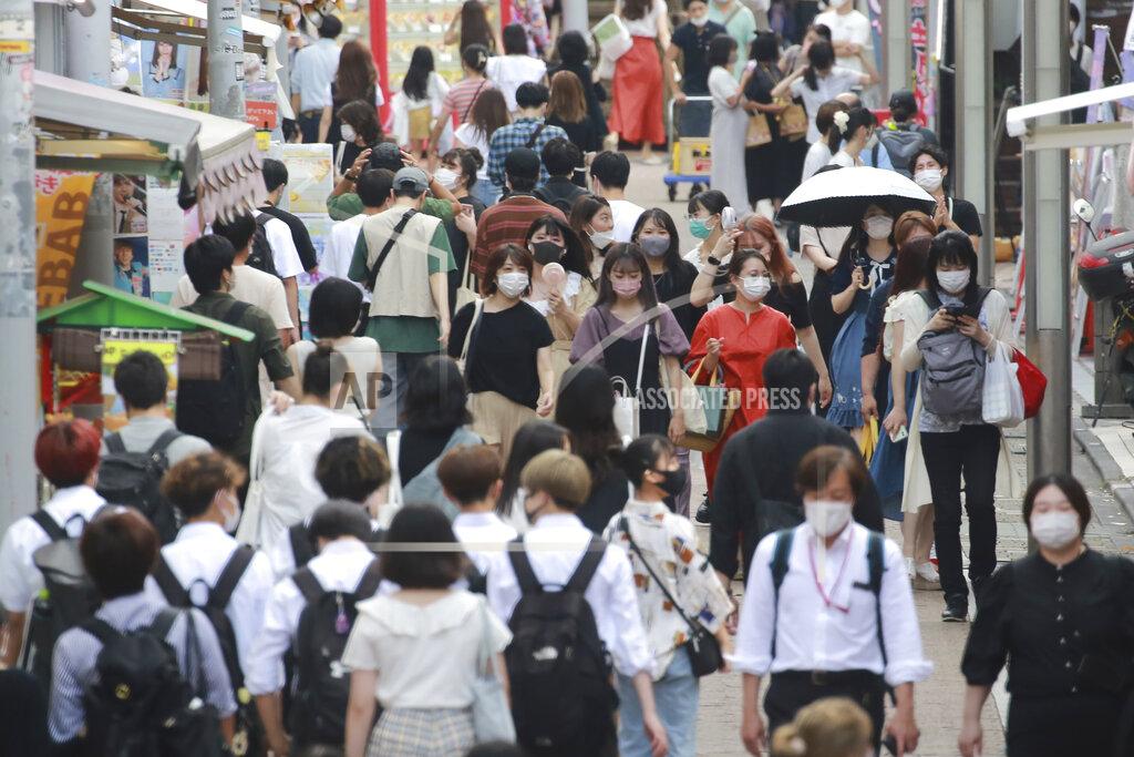 Koji Sasahara People wearing face masks to protect against the spread of the coronavirus walk through Takeshita street in Tokyo, Wednesday, July 28, 2021. Tokyo Gov. Yuriko Koike on Wednesday urged younger people to cooperate with measures to bring down the high number of infections and get vaccinated, saying their activities are key to slowing the surge during the Olympics. (AP Photo/Koji Sasahara)