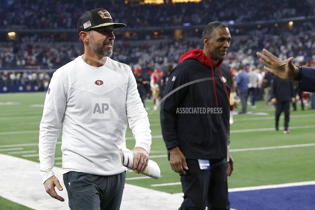 Roger Steinman San Francisco 49ers head coach Kyle Shanahan, left, walks off the field with vice president & senior advisor to the general manager and former linebacker Keena Turner after the 49ers defeated the Dallas Cowboys in an NFL wild-card playoff football game in Arlington, Texas, Sunday, Jan. 16, 2022. (AP Photo/Roger Steinman)