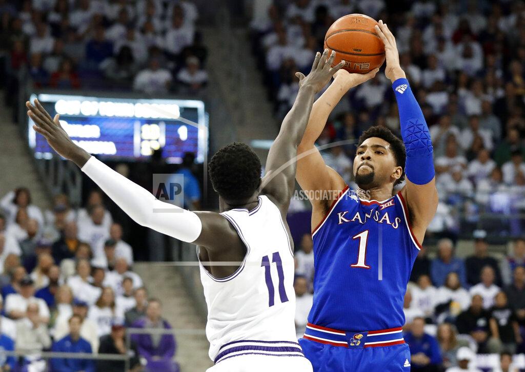 Tony Gutierrez TCU forward Lat Mayen (11) defends as Kansas forward Dedric Lawson (1) attempts a shot in the first half of an NCAA college basketball game in Fort Worth, Texas, Monday, Feb. 11, 2019. (AP Photo/Tony Gutierrez)
