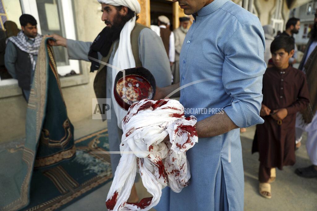 Rahmat Gul An Afghan man holds a blood-stained turban and cap inside a mosque after a bomb explosion in Shakar Dara district of Kabul, Afghanistan, Friday, May 14, 2021. A bomb ripped through a mosque in northern Kabul during Friday prayers killing 12 worshippers, Afghan police said. (AP Photo/Rahmat Gul)