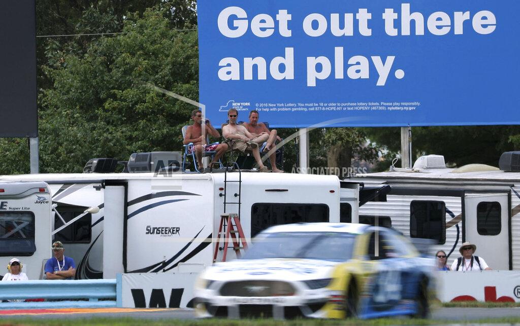 John Munson Fans watch the action during a practice run for the NASCAR Cup Series auto race at Watkins Glen International, Saturday, Aug. 3, 2019, in Watkins Glen, New York. (AP Photo/John Munson)
