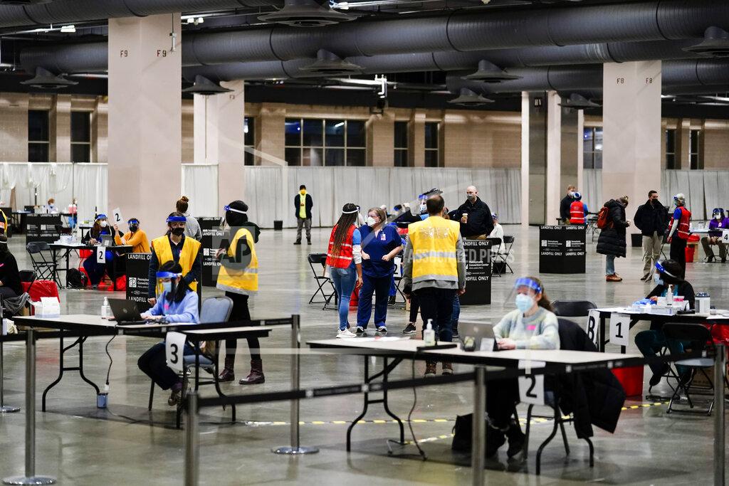 FILE - In this Feb. 3, 2021, file photo, COVID-19 vaccination site is set up at the Pennsylvania Convention Center in Philadelphia. The clinic opened to help provide second doses of the vaccine. (AP Photo/Matt Rourke, File)