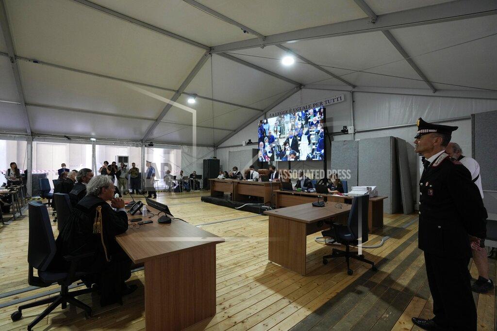 Antonio Calanni Lawyers and Judges attend the opening of the first hearing of the trial for the Morandi bridge collapse at Genoa's Palace of Justice Thursday, July 7, 2022. Forty-three people were killed when a large stretch of the Morandi Bridge broke off, August 14, 2018, on the eve of one of Italy's biggest vacation holidays. (AP Photo/Antonio Calanni)