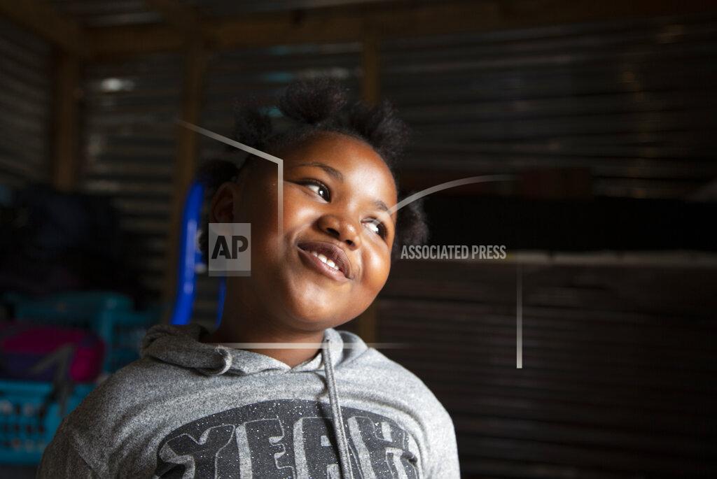 Denis Farrell Lilitha Jiphethu, 11, sings in her first language, Xhosa, inside her home in Orange Farm, South Africa, on Tuesday, April 28, 2020. “I have a friend in Jesus. He is loving and he’s not like any other friend. He is not deceitful. He is not ashamed of us. He is truthful, and He is love.” (AP Photo/Denis Farrell)
