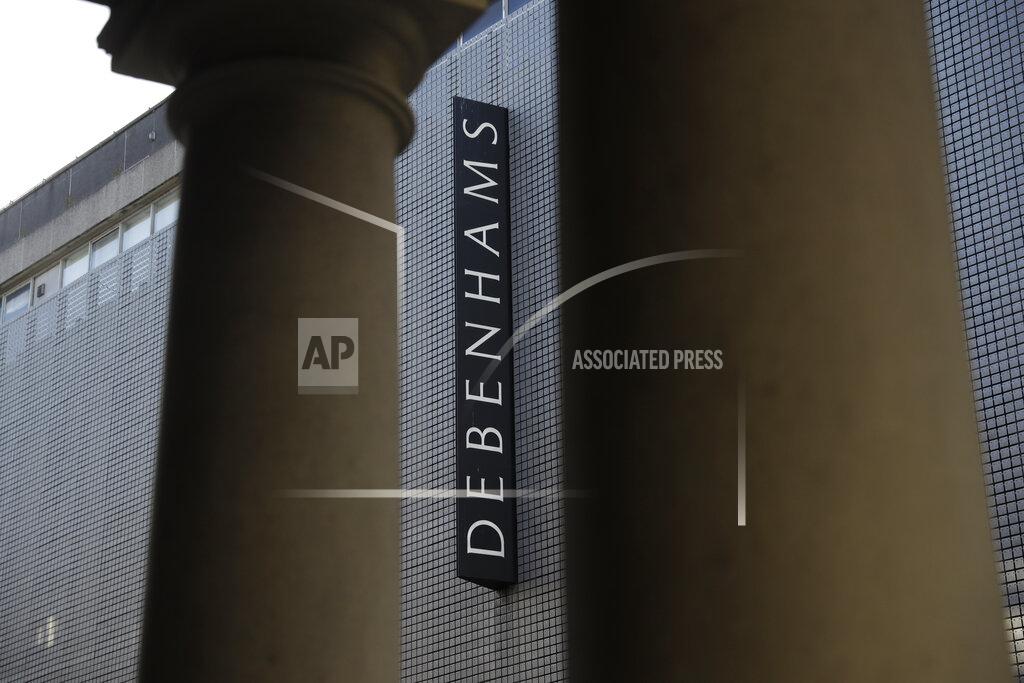 Matt Dunham The Debenhams name is displayed between the pillars of another building at the Debenhams flagship department store on a side street off Oxford Street, during England's second coronavirus lockdown in London, Tuesday, Dec. 1, 2020. In another dark day for the British retailing industry, Debenhams said Tuesday it will start liquidating its business after a potential buyer of the company pulled out, a move that looks like it will cost 12,000 workers their jobs. (AP Photo/Matt Dunham)