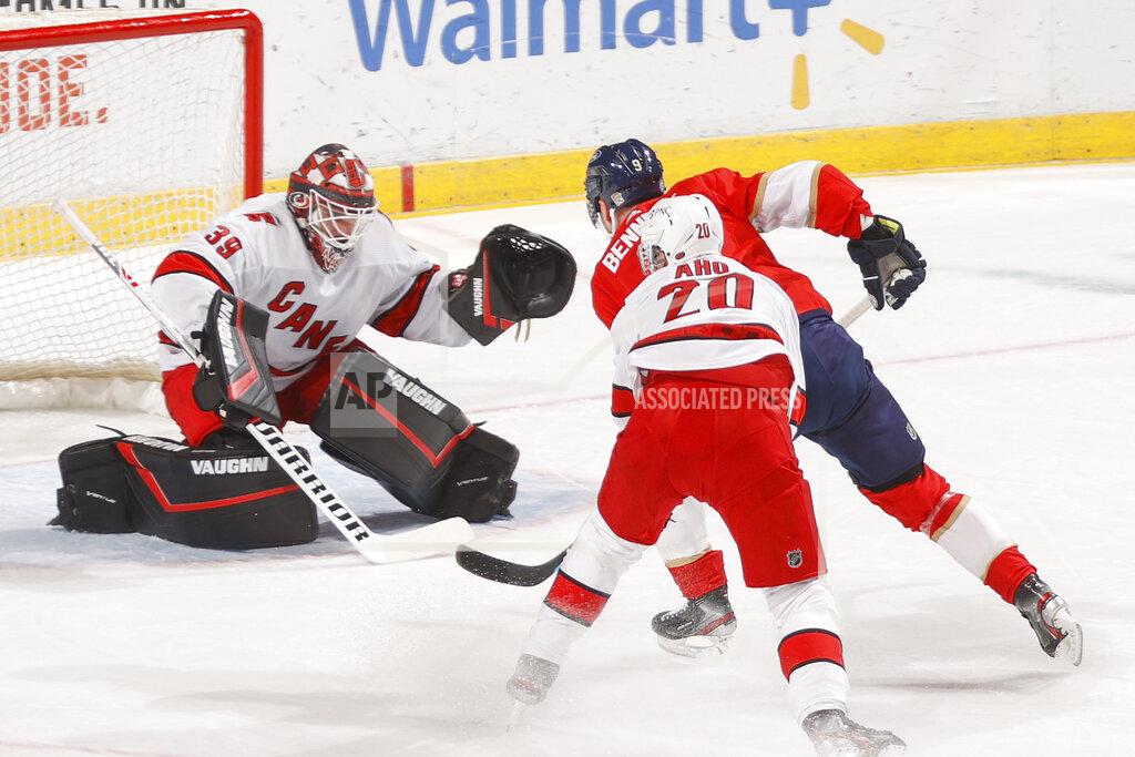 Joel Auerbach Carolina Hurricanes goaltender Alex Nedeljkovic (39) stops a shot by Florida Panthers center Sam Bennett (9) during the first period of an NHL hockey game Saturday, April 24, 2021, in Sunrise, Fla. (AP Photo/Joel Auerbach)
