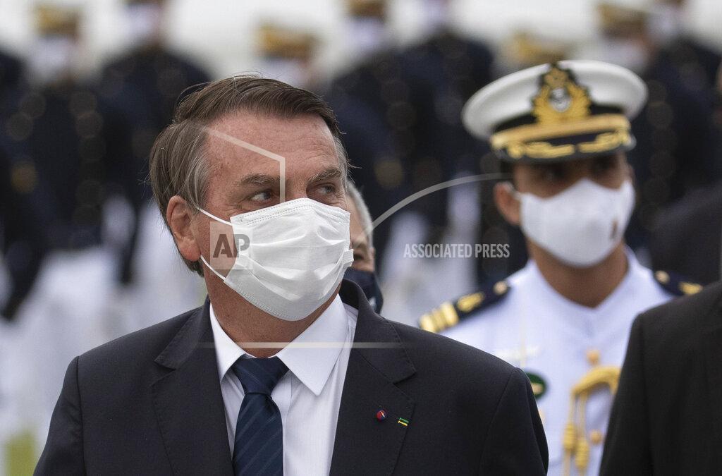 Silvia Izquierdo Brazilian President Jair Bolsonaro attends a graduation ceremony at the Naval Academy, in Rio de Janeiro, Brazil, Saturday, June 19, 2021, amid the COVID-19 pandemic. People gathered across the country Saturday, to protest Bolsonaro's handling of the pandemic and economic policies protesters say harm the interests of the poor and working class. (AP Photo/Silvia Izquierdo)