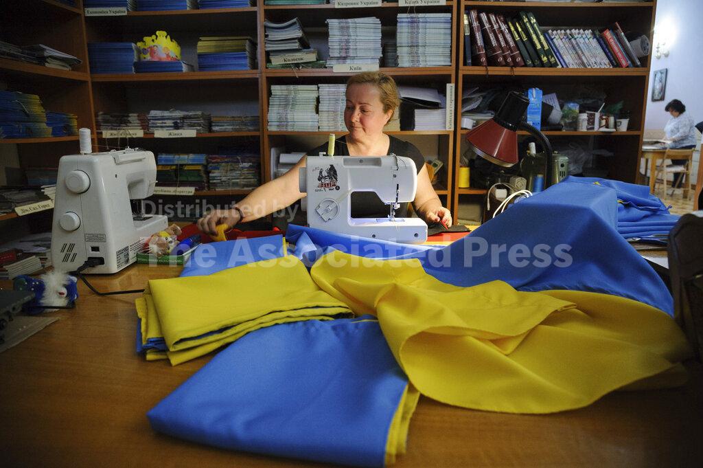 Volunteers sew Ukrainian flags for the Ukrainian military in Lviv
