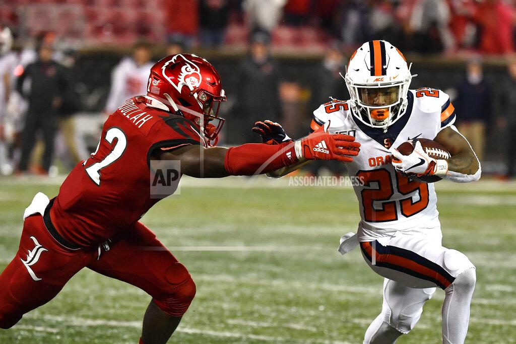 Timothy D. Easley Louisville linebacker Yasir Abdullah (22) attempts to bring down Syracuse running back Jawhar Jordan (25) during the second half of an NCAA college football game in Louisville, Ky., Saturday, Nov. 23, 2019. (AP Photo/Timothy D. Easley)