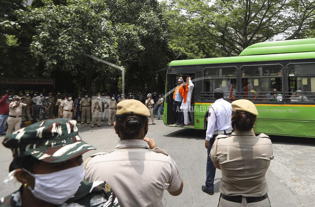 Manish Swarup Indian policemen stand guard as farmers arrive at a protest site to hold a mock farmer's parliament in New Delhi, India, Thursday, July 22, 2021. More than 200 farmers on Thursday began a protest near India's Parliament to mark eight months of their agitation against new agricultural laws that they say will devastate their income. (AP Photo/Manish Swarup)