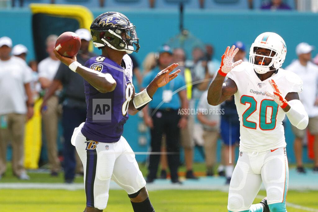 Wilfredo Lee Baltimore Ravens quarterback Lamar Jackson (8) looks to pass, as Miami Dolphins free safety Reshad Jones (20) attempts to defend, during the second half at an NFL football game, Sunday, Sept. 8, 2019, in Miami Gardens, Fla. (AP Photo/Wilfredo Lee)