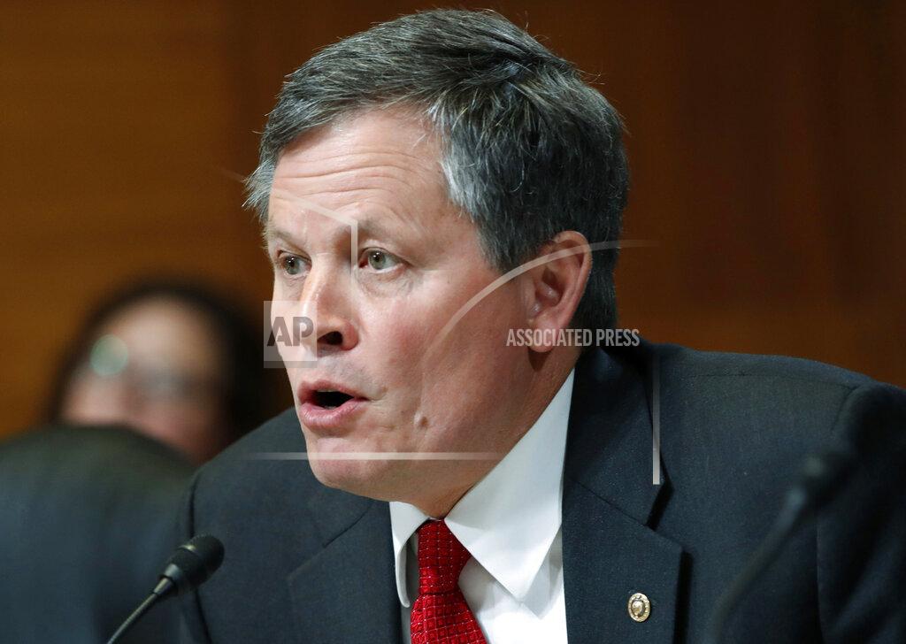 Jacquelyn Martin FILE - In this May 10, 2018 file photo, Sen. Steve Daines, R-Mont., asks a question during a Senate Appropriations subcommittee hearing on Capitol Hill in Washington. Gov. Steve Bullock, D-Mont., was the lame-duck governor of solidly red Montana, fresh off a failed Democratic presidential bid, when he pivoted and announced he’d challenge Republican Sen. Steve Daines for his seat. But days after he announced his candidacy last month, the coronavirus claimed its first cases in Montana. That shifted the spotlight onto Bullock as he leads the state’s pandemic response, leaving Daines in the unusual position of a sitting senator competing for attention. (AP Photo/Jacquelyn Martin, File)