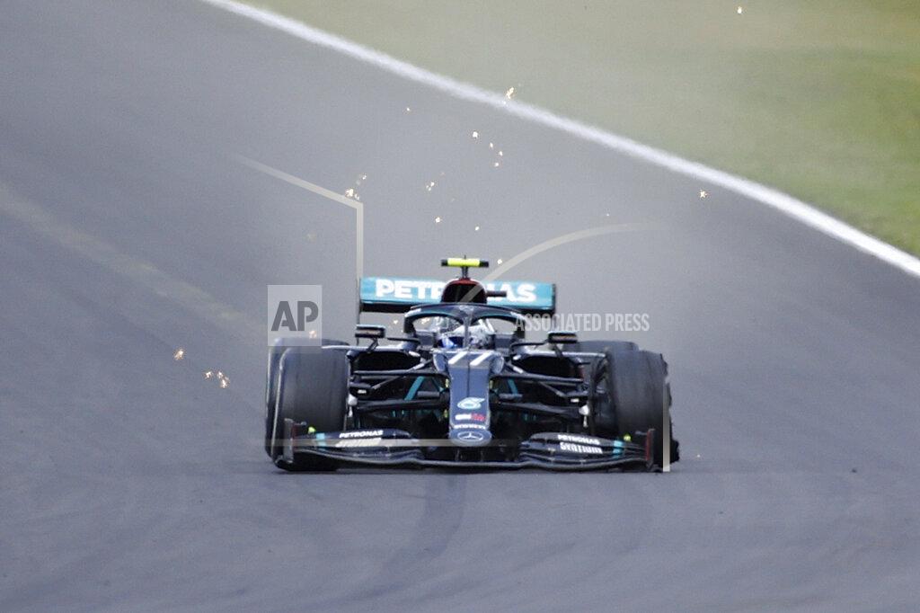 Andrew Boyers Mercedes driver Valtteri Bottas of Finland steers his car with a flat tire during the British Formula One Grand Prix at the Silverstone racetrack, Silverstone, England, Sunday, Aug. 2, 2020. (Andrew Boyers/Pool via AP)