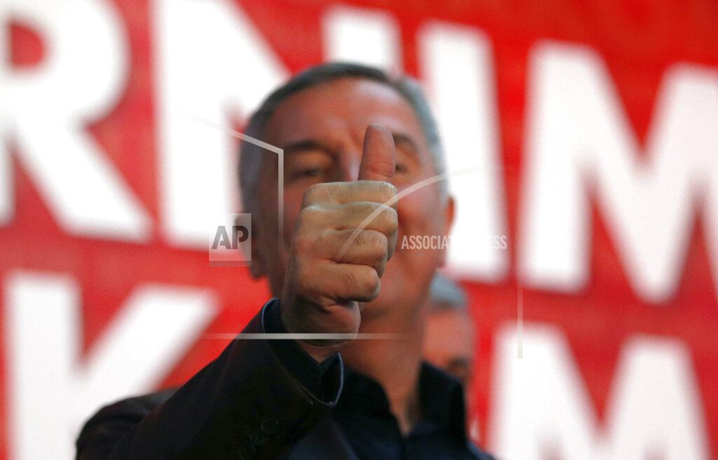 Darko Vojinovic FILE - In this Monday, Oct. 17, 2016 file photo, long-ruling Democratic Party of Socialists leader Milo Djukanovic, gives a thumbs up in his headquarter, in Podgorica, Montenegro. Montenegro's President Milo Djukanovic says the upcoming parliamentary vote is crucial in the defense of the small Balkan country's independence in the face of renewed attempts from Serbia and Russia to install their nationalist and anti-Western allies to power. (AP Photo/Darko Vojinovic, File)