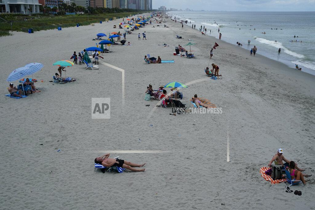 Beachgoers line the sand Thursday, July 9, 2020, in Myrtle Beach, S.C. (AP Photo/Chris Carlson)