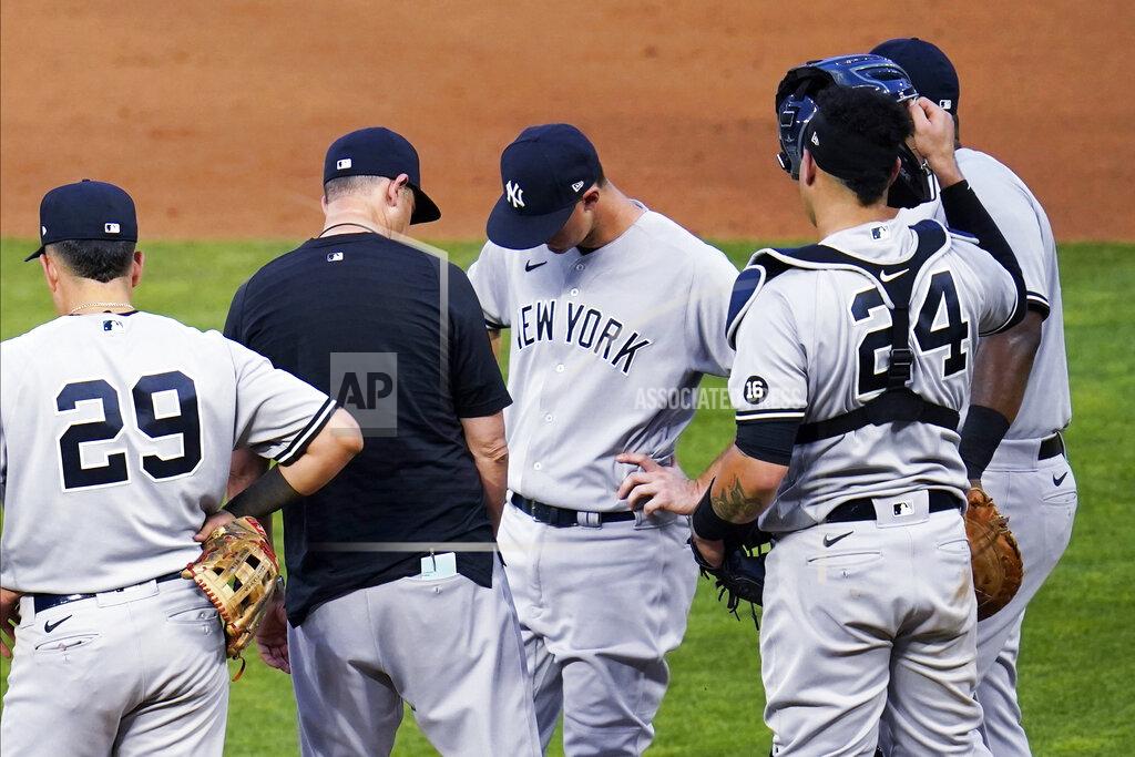 Jim Mone New York Yankees manager Aaron Boone, in black, talks with pitcher Michael King, center, before pulling him during the fourth inning of the team's baseball game against the Minnesota Twins on Thursday, June 10, 2021, in Minneapolis. (AP Photo/Jim Mone)