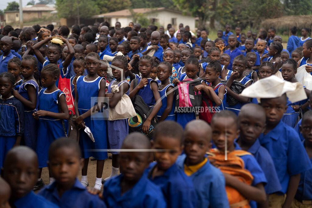 Leo Correa Primary students gather in line before they enter their classrooms at Kombayendeh village in Lei chiefdom, district of Kono, Sierra Leone, Friday, Nov. 27, 2020. Early marriages were happening so often in this part of Sierra Leone that traditional leaders in the Lei chiefdom instituted a new bylaw imposing a 500,000 ($50) fine on anyone having sex with a minor, even if the man is married to the child. Yet local leaders in Kombayendeh can't recall a single fine being issued. (AP Photo/Leo Correa)