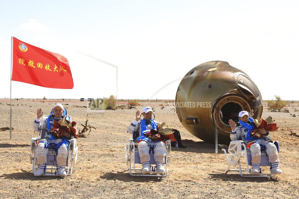 Ju Zhenhua In this photo released by Xinhua News Agency, Chinese astronauts from left, Tang Hongbo, Nie Haisheng and Liu Boming wave at the Dongfeng landing site in northern China's Inner Mongolia Autonomous Region on Friday, Sept. 17, 2021. The trio of Chinese astronauts returned to Earth on Friday after a 90-day stay aboard their nation's first space station in China's longest mission yet.(Ju Zhenhua/Xinhua via AP)