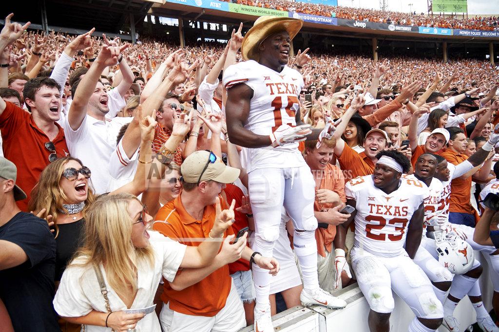 Cooper Neill Texas defensive back Chris Brown (15) wears the Golden Hat and celebrates with fans after defeating Oklahoma 48-45 in an NCAA college football game at the Cotton Bowl, Saturday, Oct. 6, 2018, in Dallas. (AP Photo/Cooper Neill)