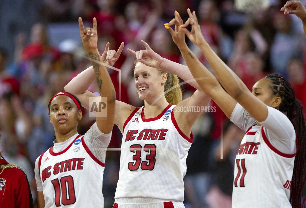 Ben Mckeown North Carolina State's Aziaha James (10), Elissa Cunane (33), and Jakia Brown-Turner (11) gesture to the crowd following their victory over Longwood in a college basketball game in the first round of the NCAA tournament in Raleigh, N.C., Saturday, March 19, 2022. (AP Photo/Ben McKeown)