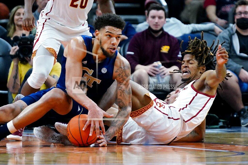 Ross D. Franklin Georgia Tech center Rodney Howard, left, controls a loose ball as Southern California guard Isaiah White, right, falls away from the ball during the first half of an NCAA college basketball game at the Jerry Colangelo Classic Saturday, Dec. 18, 2021, in Phoenix. (AP Photo/Ross D. Franklin)