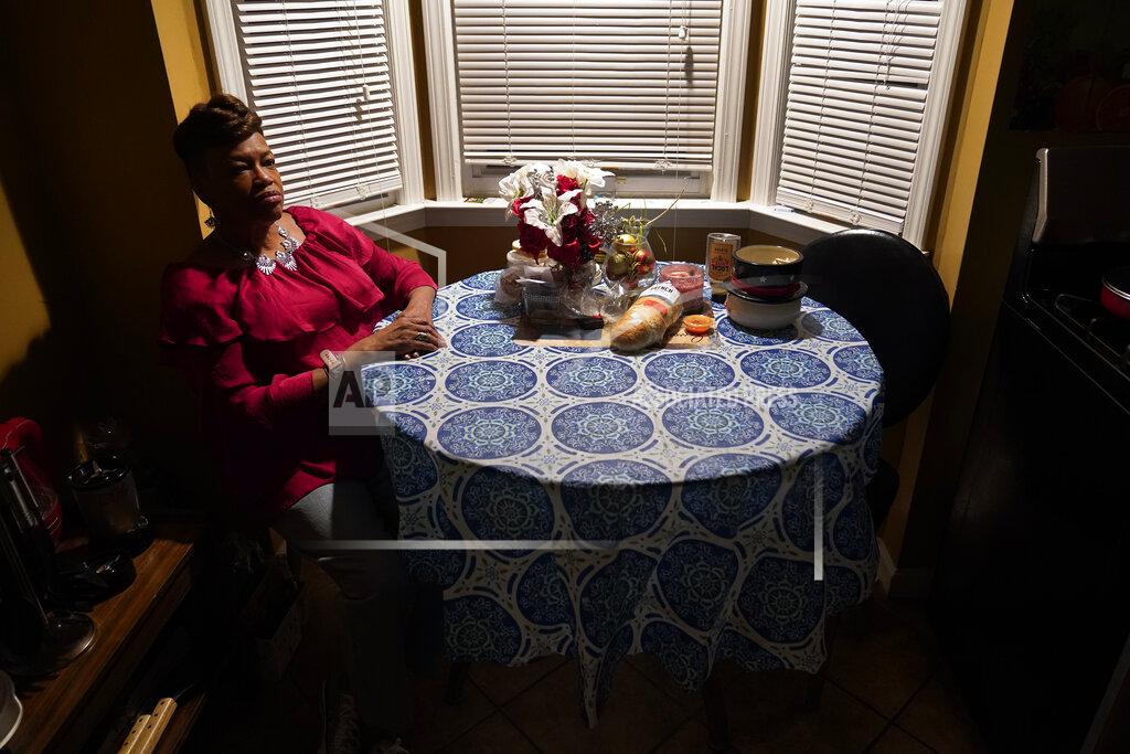 Paul Sancya Karla Jefferies sits in her kitchen in Detroit, Friday, March 5, 2021. Jefferies, 64, a retired state worker in Detroit, Michigan, tested positive for COVID-19 in March 2020 and has been bothered by puzzling symptoms ever since. First it was fatigue, fever, and no taste or smell. Then came brain fog, insomnia, a nagging smell of something burning that only recently disappeared, and intermittent ringing in her ears. Now she can't hear out of her left ear. (AP Photo/Paul Sancya)