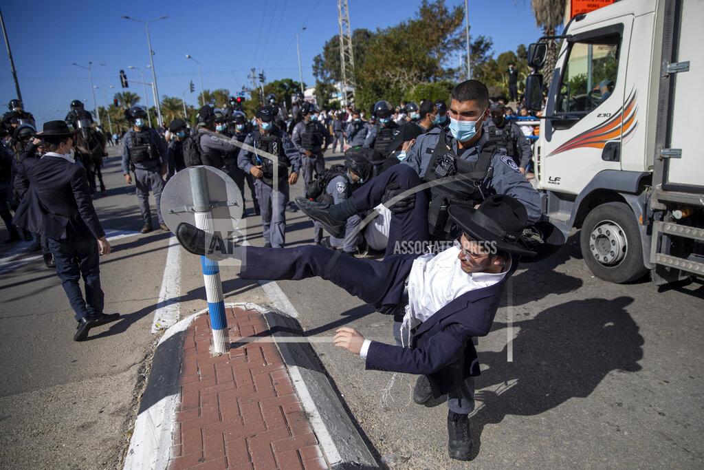 Oded Balilty File - In this Sunday, Jan. 24, 2021 file photo, Israeli police officers clash with ultra-Orthodox Jews in Ashdod, Israel,. Ultra-Orthodox demonstrators clashed with Israeli police officers dispatched to close schools in Jerusalem and Ashdod that had opened in violation of coronavirus lockdown rules, on Sunday. (AP Photo/Oded Balilty, File)