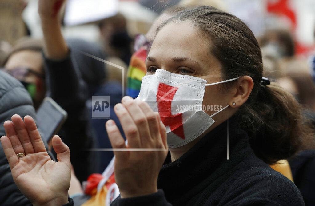 Czarek Sokolowski Women's rights activists protest against recent tightening of Poland's restrictive abortion law, in front of the parliament building as inside, guards had to be used to shield right-wing ruling party leader Jaroslaw Kaczynski from angry opposition lawmakers, in Warsaw, Poland, Wednesday, Oct. 28, 2020. Massive nationwide protests have been held ever since a top court ruled Thursday that abortions due to fetal congenital defects are unconstitutional.(AP Photo/Czarek Sokolowski)
