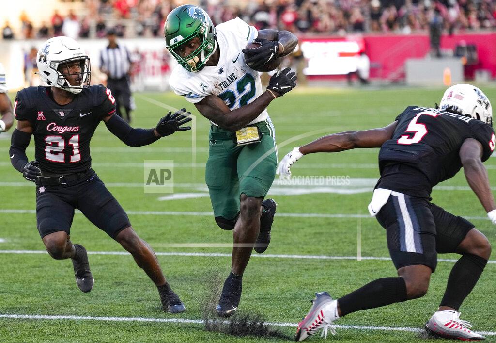 Brett Coomer Tulane running back Tyjae Spears (22) cuts back between Houston defensive backs Abdul-Lateef Audu (21) and Hasaan Hypolite (5) on a reception for a first down during the second quarter of an NCAA college football game Friday, Sept. 30, 2022, in Houston. (Brett Coomer/Houston Chronicle via AP)