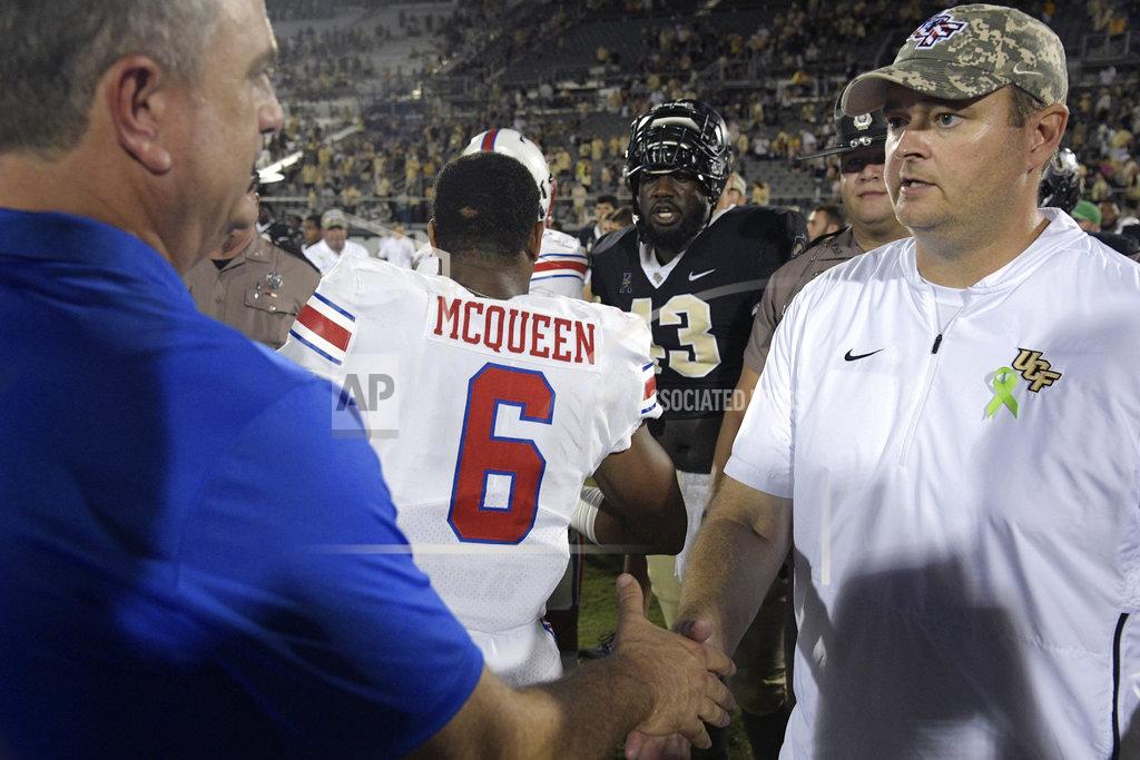Phelan M. Ebenhack SMU head coach Sonny Dykes, left, shakes hands with Central Florida head coach Josh Heupel on the field after an NCAA college football game Saturday, Oct. 6, 2018, in Orlando, Fla. UCF won 48-20. (AP Photo/Phelan M. Ebenhack)