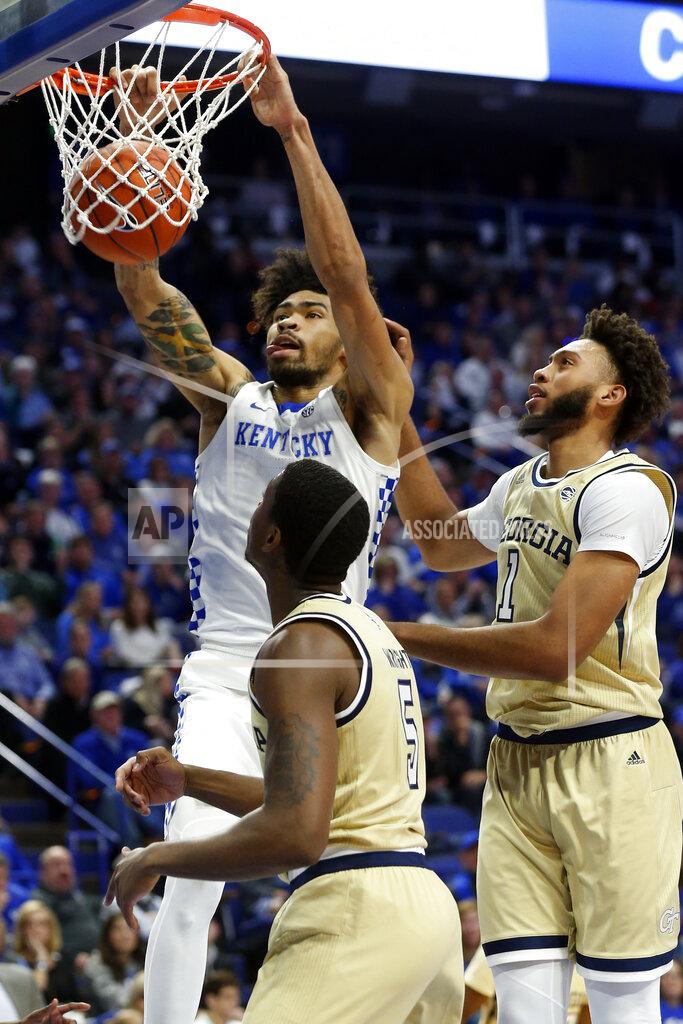 James Crisp Kentucky's Nick Richards, top left, dunks near Georgia Tech's Moses Wright (5) and James Banks III during the first half of an NCAA college basketball game in Lexington, Ky., Saturday, Dec. 14, 2019. (AP Photo/James Crisp)