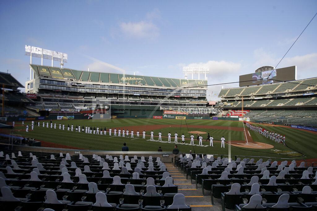 Jeff Chiu Players and coaches from the Oakland Athletics and the Los Angeles Angels hold a black ribbon in honor of the Black Lives Matter movement before the teams played a baseball game in Oakland, Calif., Friday, July 24, 2020. (AP Photo/Jeff Chiu)