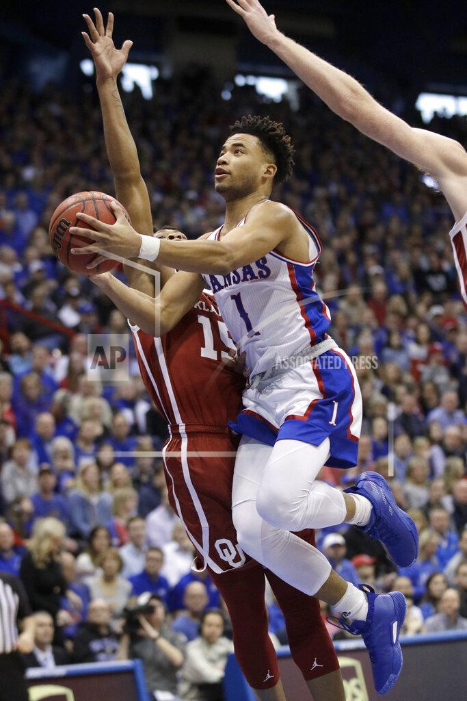Orlin Wagner Kansas guard Devon Dotson (1) drives for a basket past Oklahoma guard Alondes Williams (15) during the first half of an NCAA college basketball game in Lawrence, Kan., Saturday, Feb. 15, 2020. (AP Photo/Orlin Wagner)