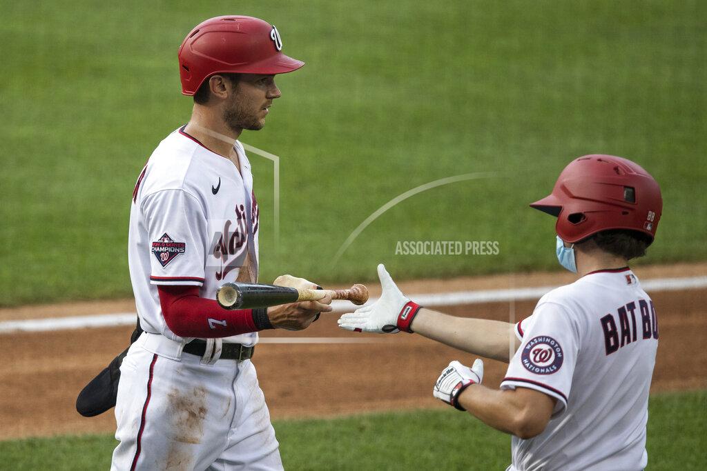 Alex Brandon Washington Nationals' Trea Turner (7) hands a bat to the bat boy during the first inning of an exhibition baseball game against the Baltimore Orioles at Nationals Park, Tuesday, July 21, 2020, in Washington. (AP Photo/Alex Brandon)