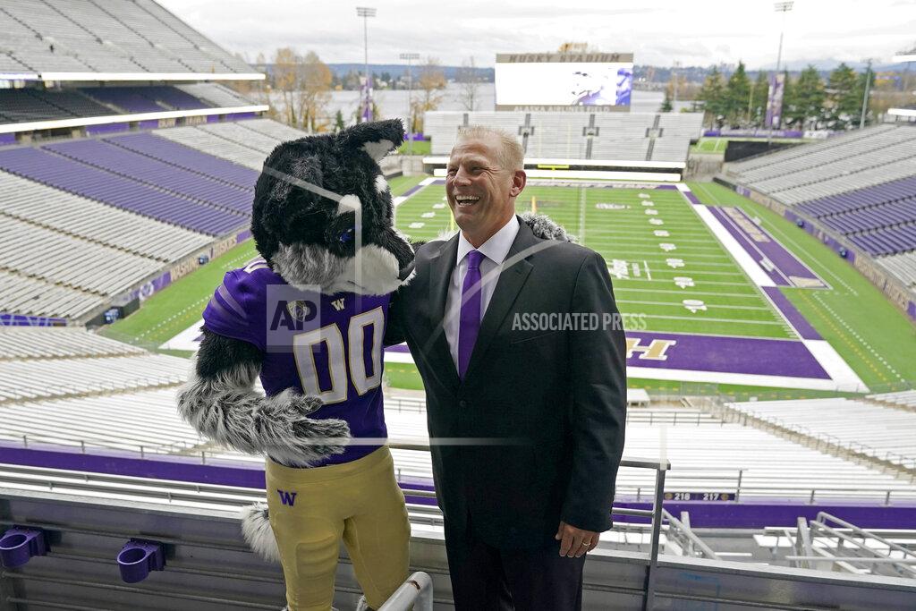 Ted S. Warren Kalen DeBoer reacts as he poses for photo with Harry, the Washington mascot, Tuesday, Nov. 30, 2021, at Husky Stadium in Seattle, following a news conference in Seattle to introduce DeBoer as the new head NCAA college football coach at the University of Washington. DeBoer has spent the past two seasons as head football coach at Fresno State. (AP Photo/Ted S. Warren)
