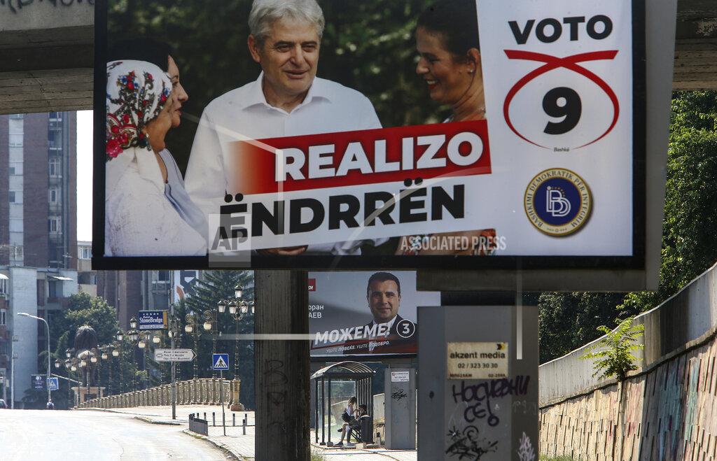 Boris Grdanoski Electoral campaign poster of the leader of the ethnic Albanian party Democratic Union for Integrations (DUI) Ali Ahmeti, top, and the poster of the leader of the ruling Social Democrats Zoran Zaev, bottom, are displayed in a street in Skopje, North Macedonia on Saturday, July 11, 2020. North Macedonia holds its first parliamentary election under its new country name this week, with voters heading to the polls during an alarming spike of coronavirus cases in the small Balkan nation. (AP Photo/Boris Grdanoski)