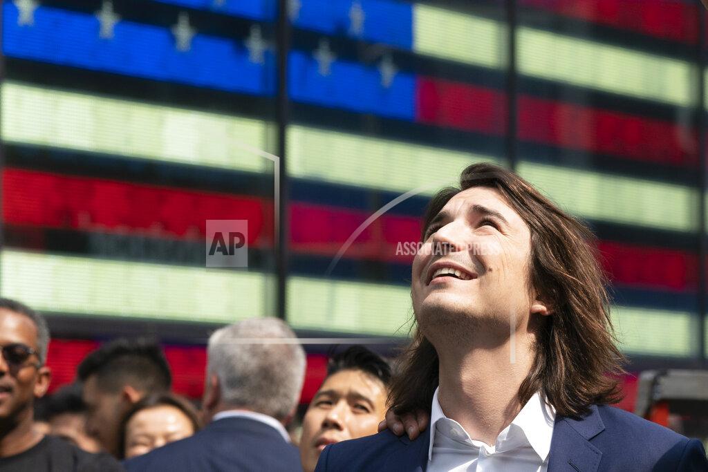 Mark Lennihan Vladimir Tenev, CEO and co-founder of Robinhood, celebrates in New York's Times Square following his company's IPO, Thursday, July 29, 2021. Robinhood has already changed how people trade stocks and who's doing it. Now its sights are on the rest of the financial industry.(AP Photo/Mark Lennihan)
