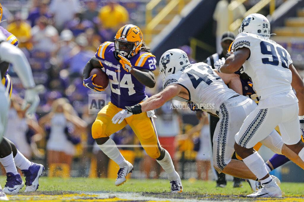 Gerald Herbert LSU running back Chris Curry (24) carries against Utah State defensive end Nick Heninger (42) in the second half of an NCAA college football game in Baton Rouge, La., Saturday, Oct. 5, 2019. (AP Photo/Gerald Herbert)