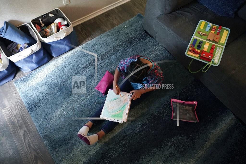 Eric Gay Felicity Brown, 9, draws as she takes a break from math practice at her home in Austin, Texas, Tuesday, July 13, 2021. After homeschooling during the pandemic, the Brown family have switched to homeschooling their kids permanently using a Catholic-based curriculum and won't be sending them back to in-person schools this fall. (AP Photo/Eric Gay)