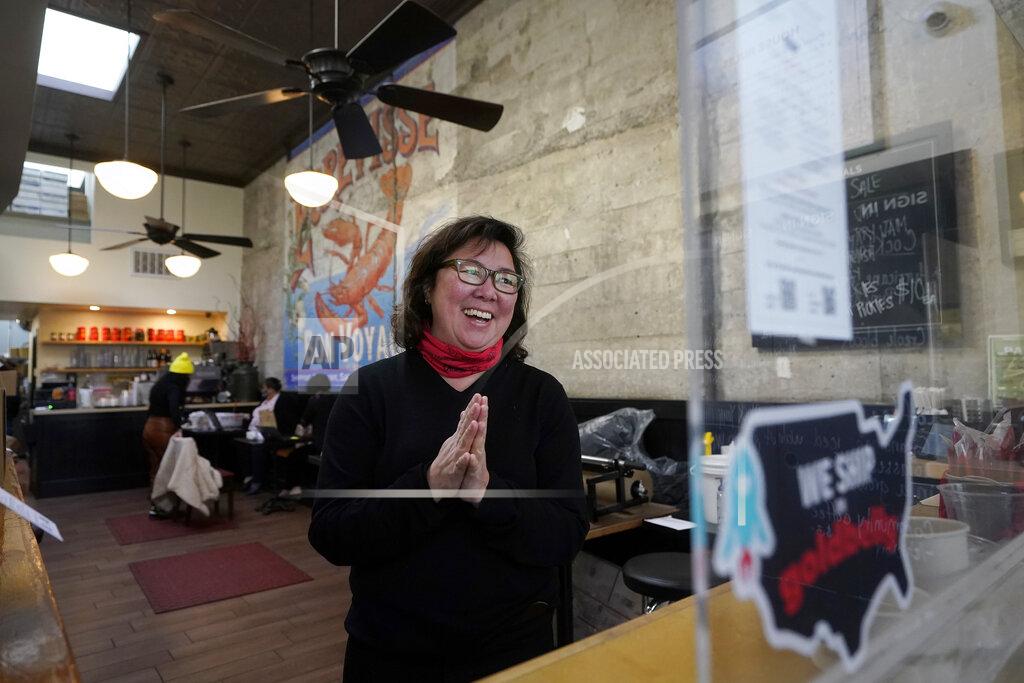 Chef Proprieter Brenda Buenviaje smiles as she is interviewed at Brenda's French Soul Food in San Francisco, Wednesday, Dec. 9, 2020. In pre-pandemic days, Brenda's French Soul Food was always hopping, but everything came to a screeching halt on March 16, when San Francisco halted indoor dining to stop the spread of the coronavirus. It reopened for takeout and delivery, and Buenviaje is now shipping meals nationwide through a service called Goldbelly. (AP Photo/Jeff Chiu)